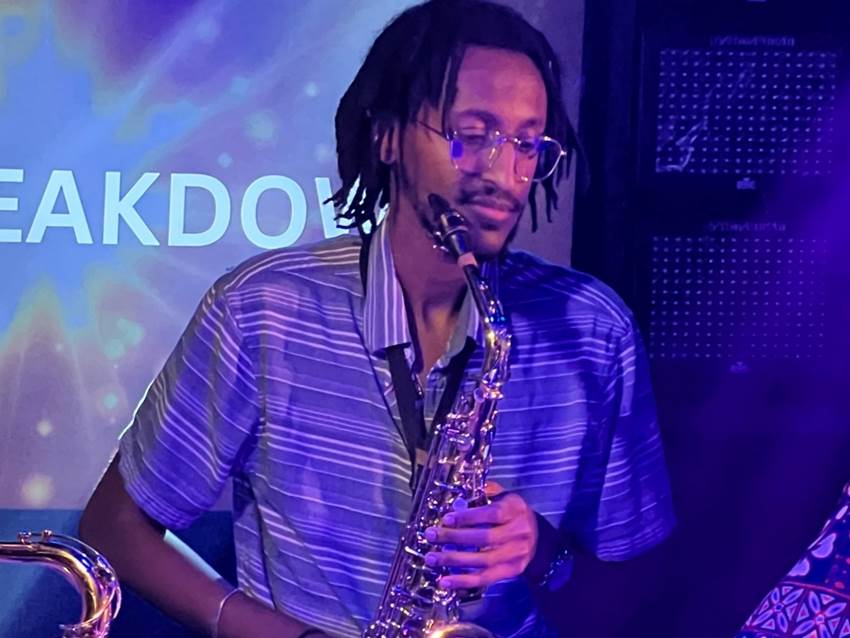A person playing a saxophone

Description automatically generated
